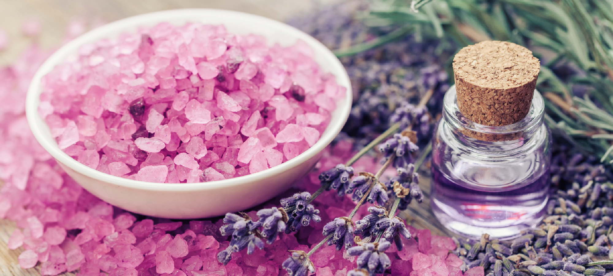 Aromatic sea salt, bottle of essential oil and lavender flowers. Selective focus.
